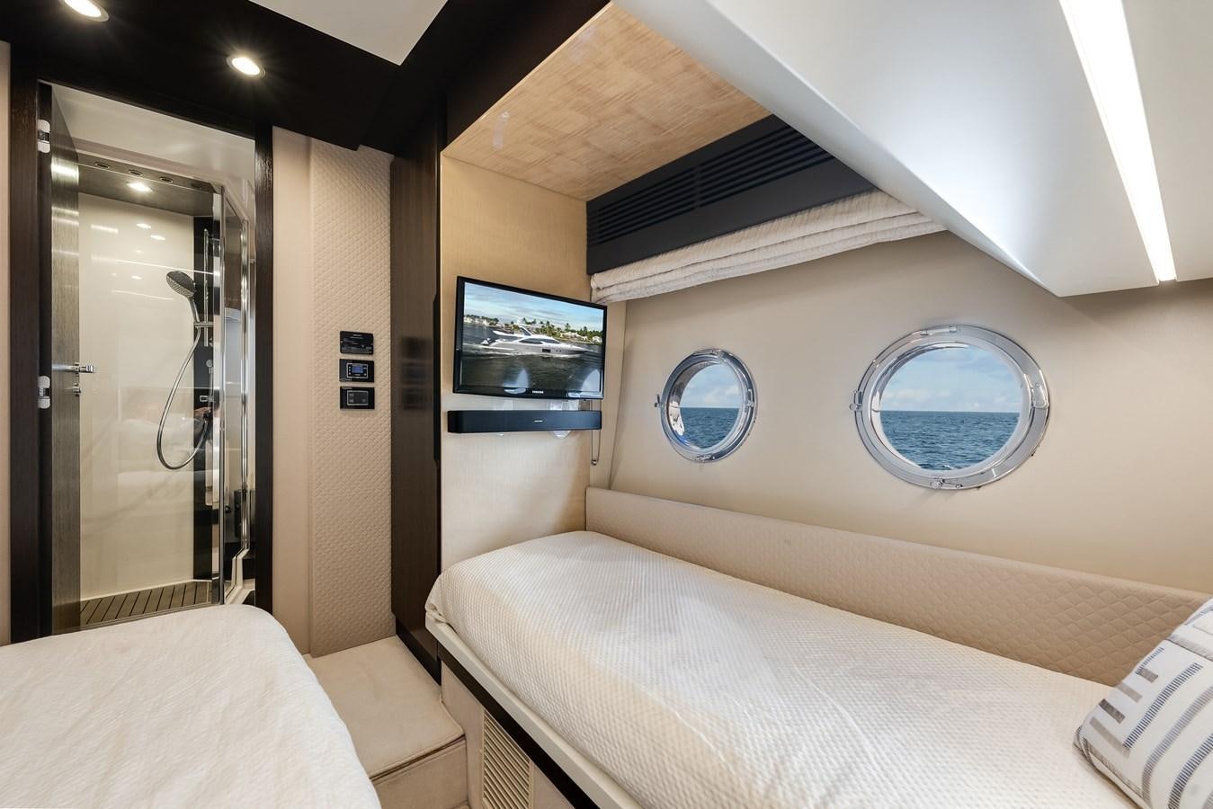a room with a bed and a tv on the wall aboard TRUTH SERUM Yacht for Sale