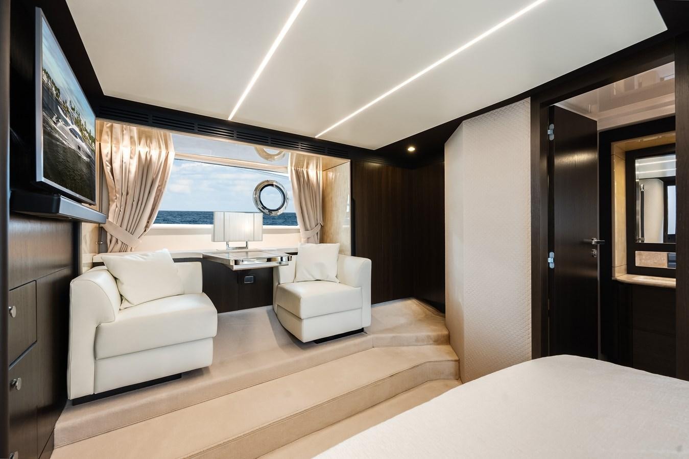 a room with a bed and a tv on the wall aboard TRUTH SERUM Yacht for Sale