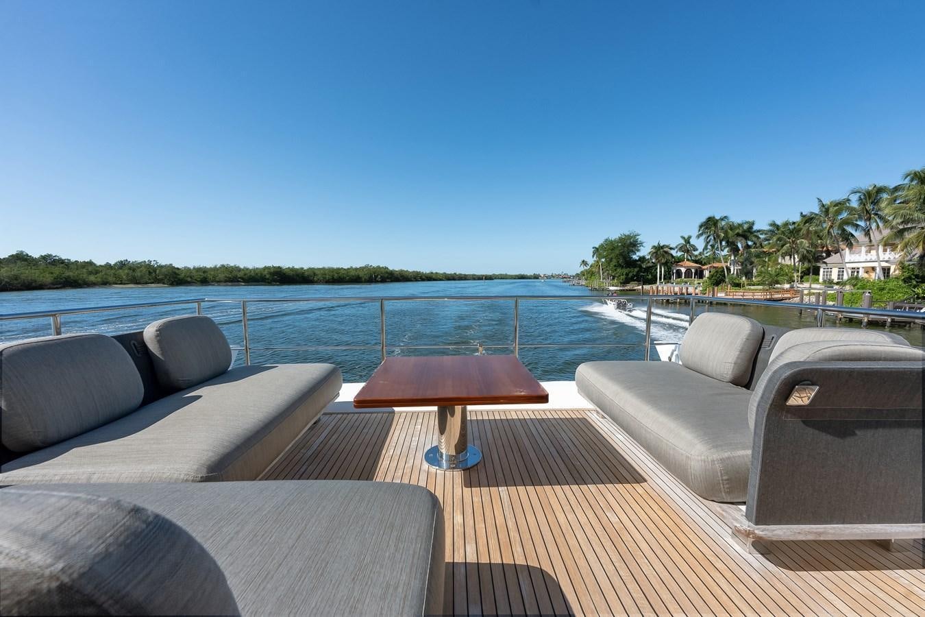a deck with a pool and a deck with chairs and trees aboard TRUTH SERUM Yacht for Sale