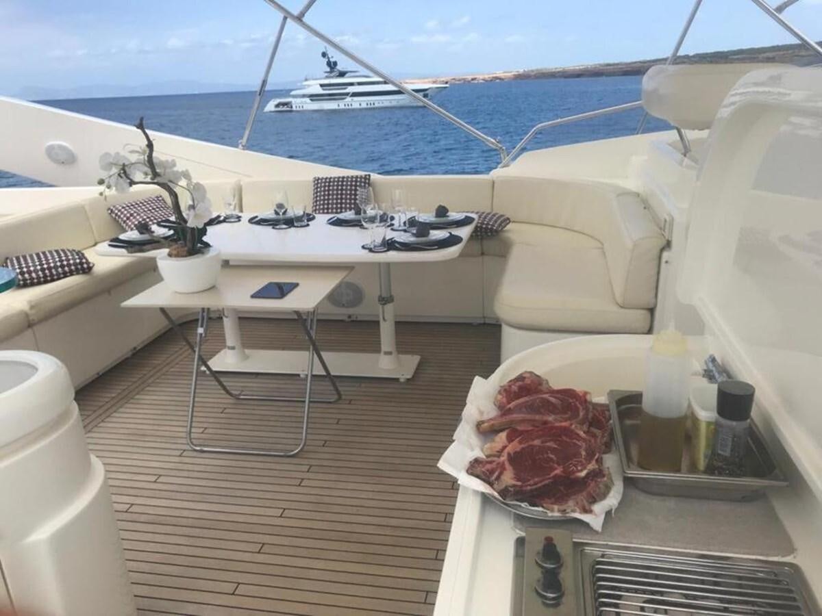 a table on a deck aboard CAMARIK Yacht for Sale
