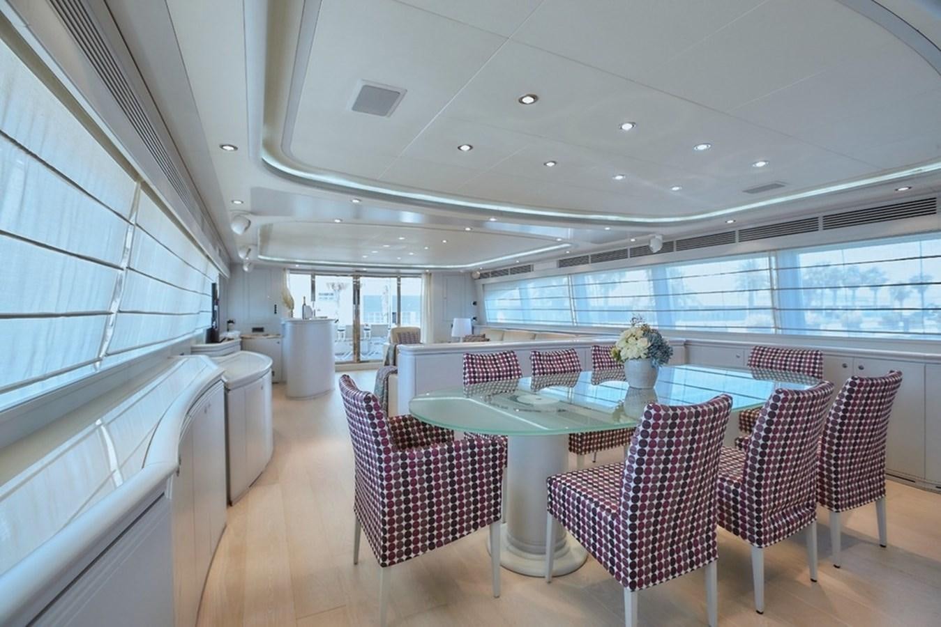a large room with a table and chairs aboard CAMARIK Yacht for Sale