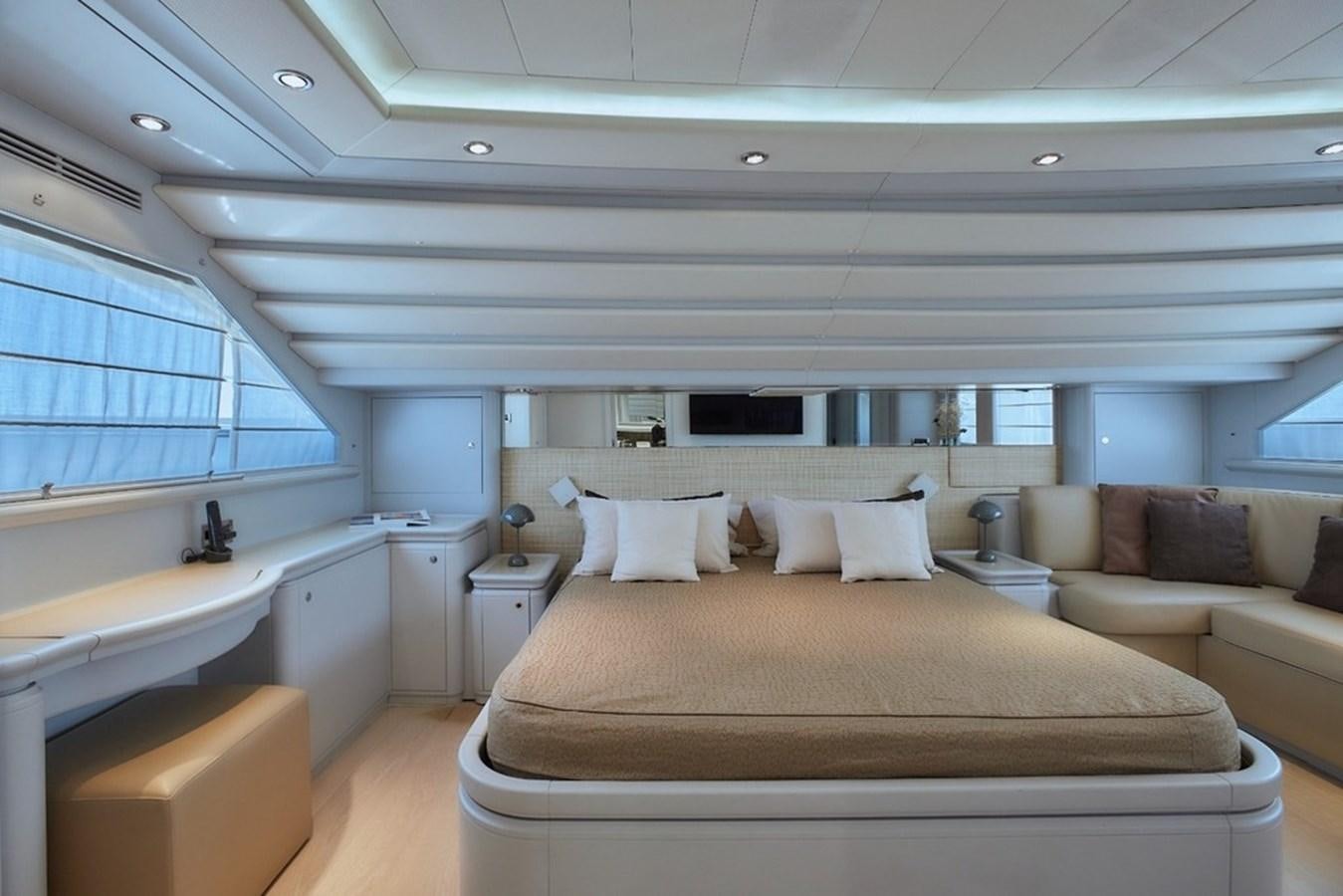 a large white room with a couch and a large window aboard CAMARIK Yacht for Sale