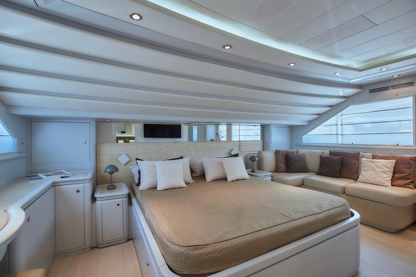 a bedroom with a bed and a couch aboard CAMARIK Yacht for Sale