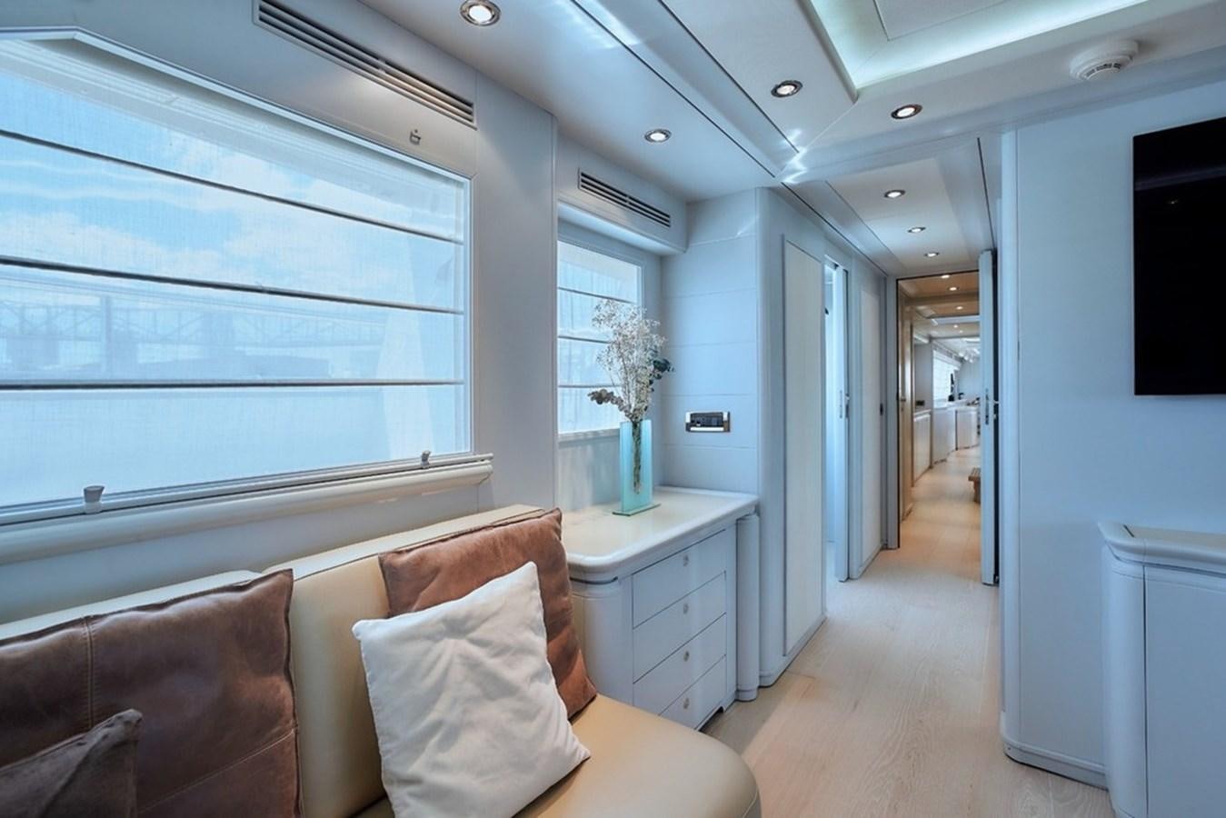 a living room with a couch and a large window aboard CAMARIK Yacht for Sale