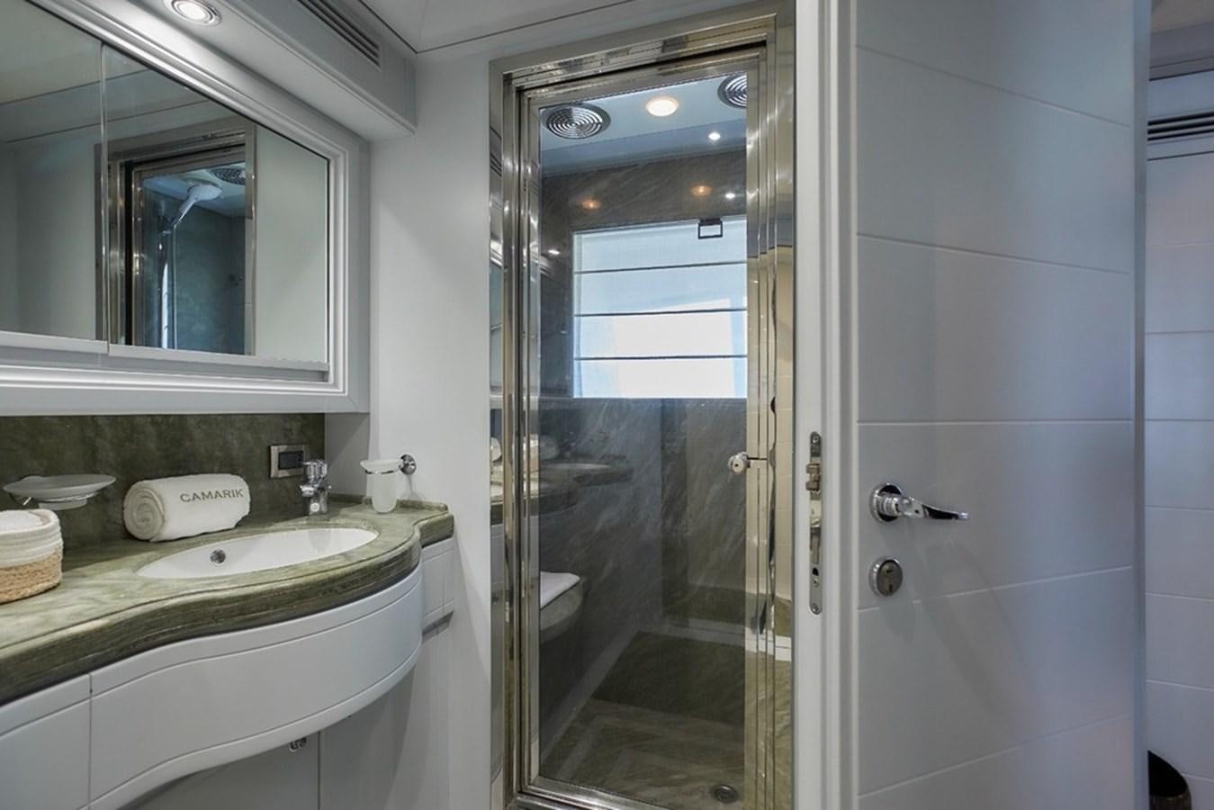 a bathroom with a glass shower aboard CAMARIK Yacht for Sale