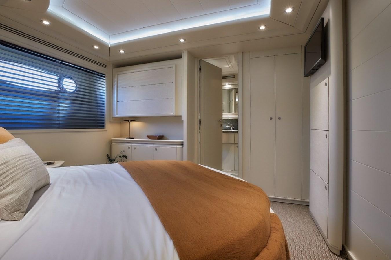 a bedroom with a bed and a television aboard CAMARIK Yacht for Sale