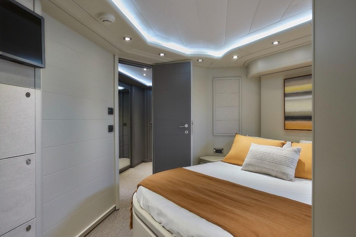a bedroom with a bed and a tv aboard CAMARIK Yacht for Sale