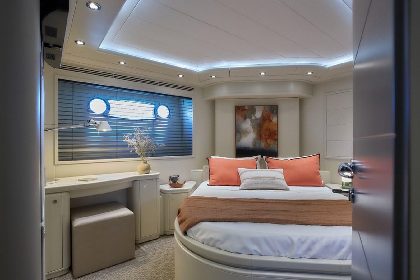 a bedroom with a bed and a desk aboard CAMARIK Yacht for Sale