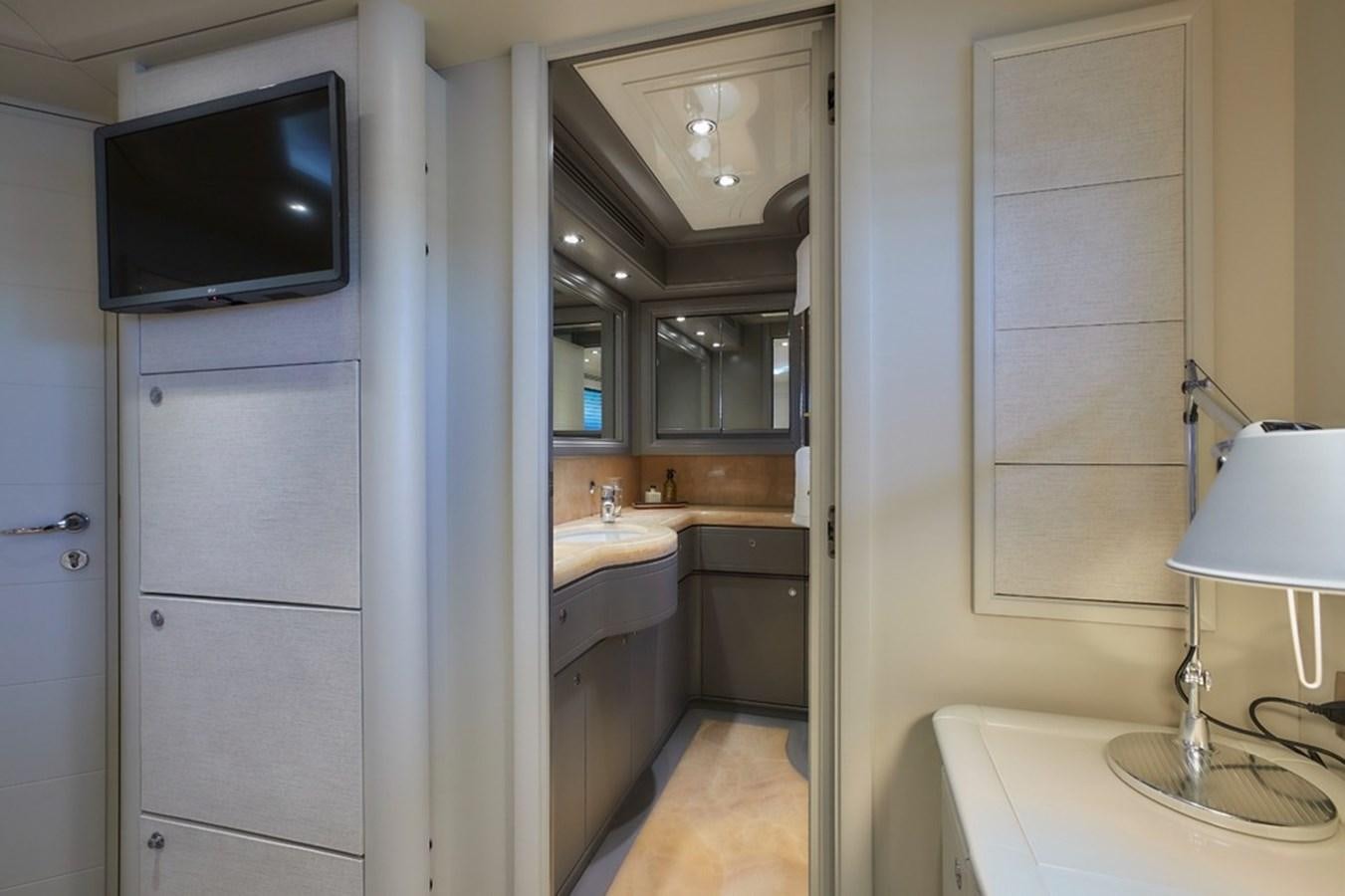 a bathroom with a sink and a tv on the wall aboard CAMARIK Yacht for Sale