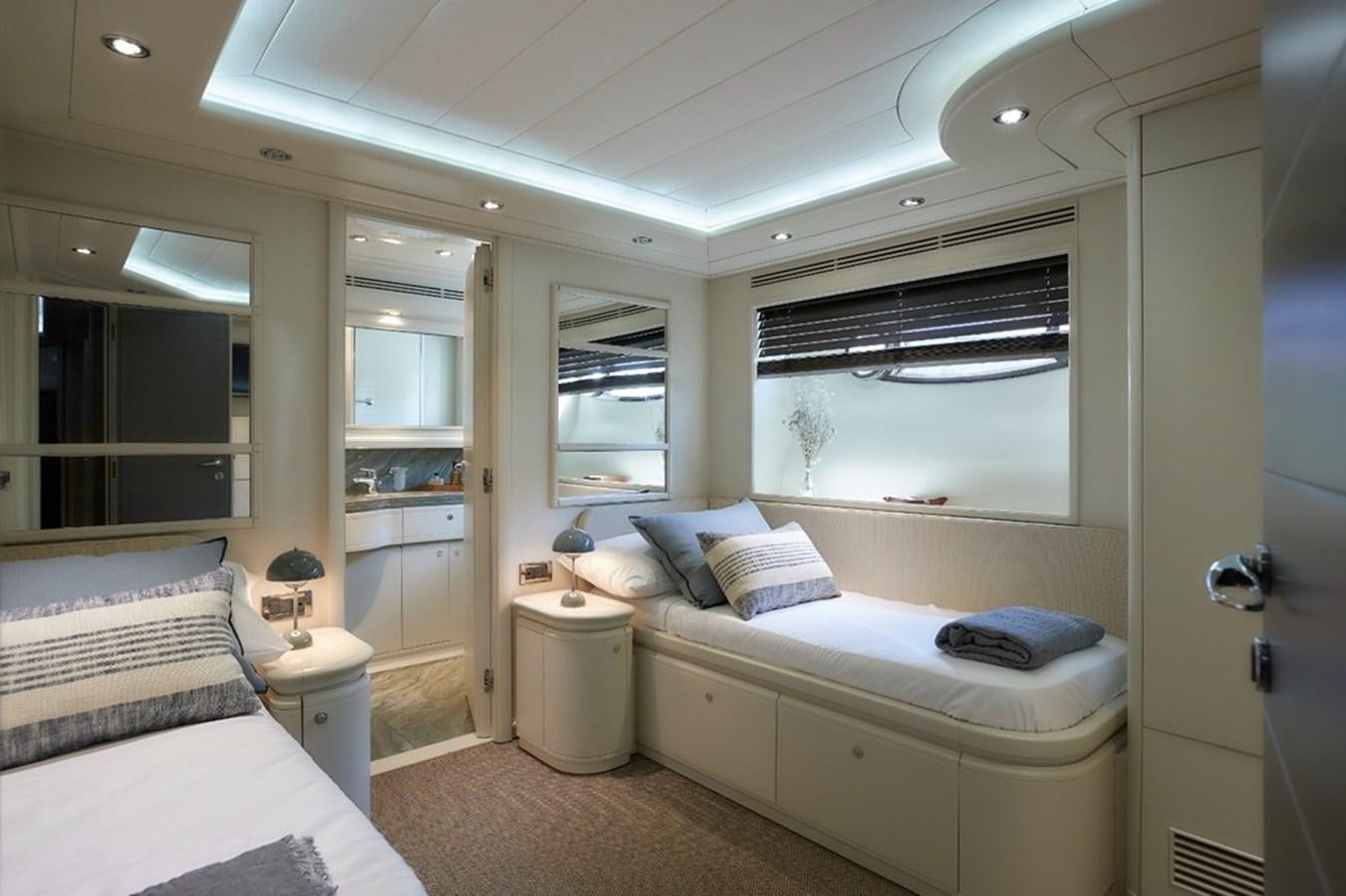a bedroom with a bed and a mirror aboard CAMARIK Yacht for Sale