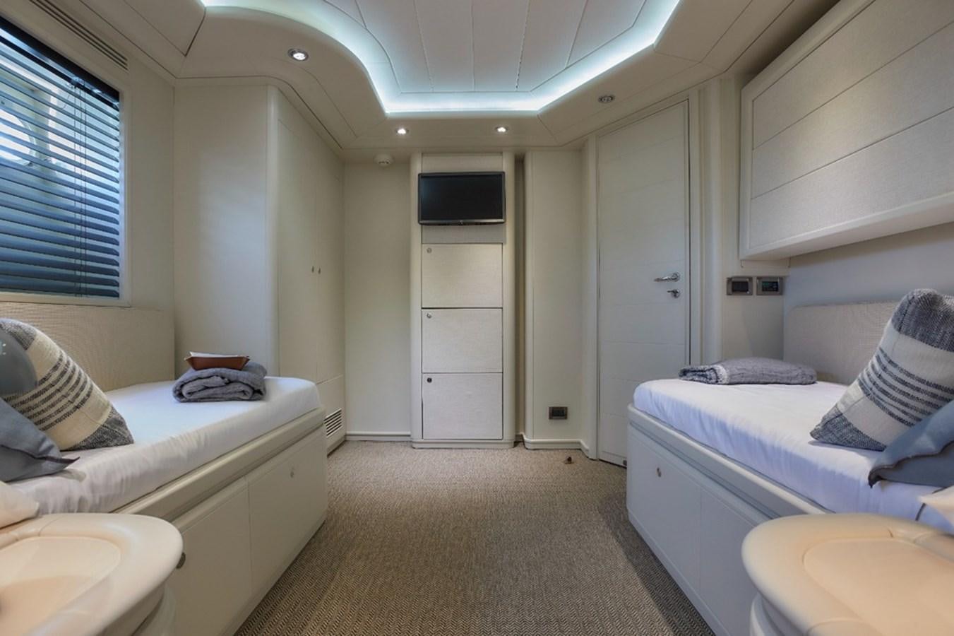 a room with beds and a door aboard CAMARIK Yacht for Sale
