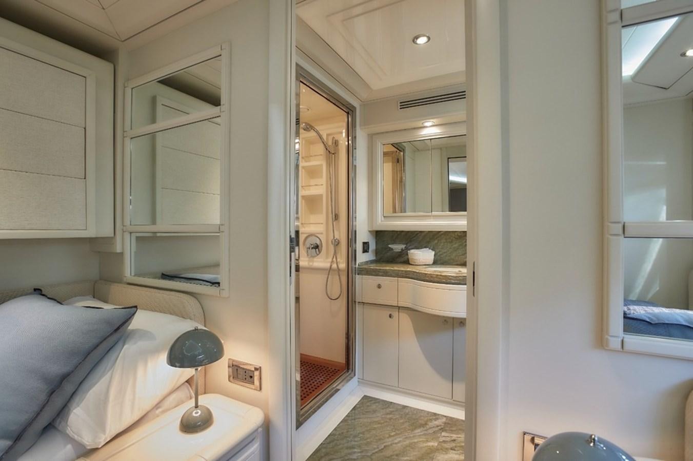 a bedroom with a bed and a mirror aboard CAMARIK Yacht for Sale