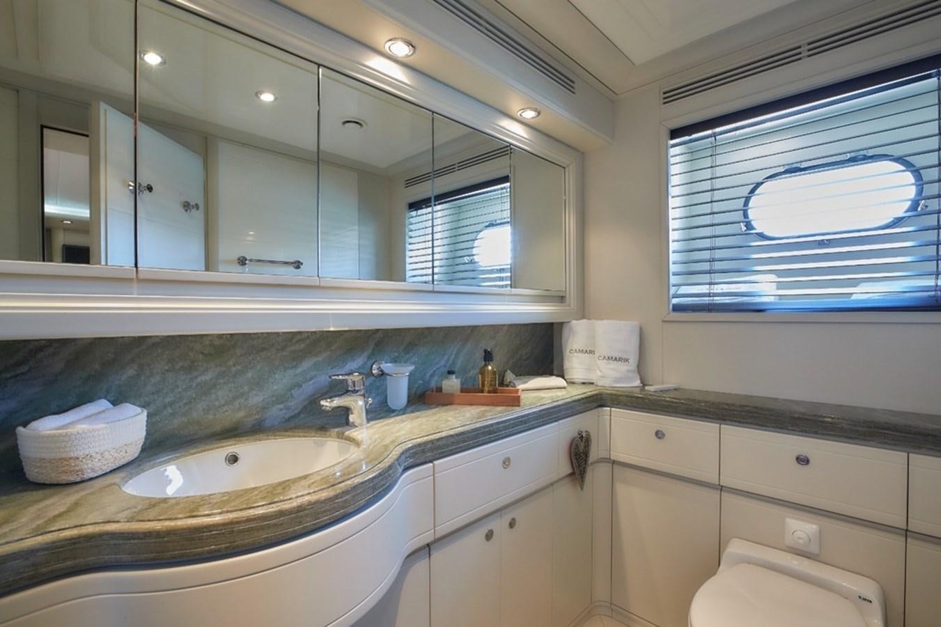 a bathroom with a large mirror aboard CAMARIK Yacht for Sale