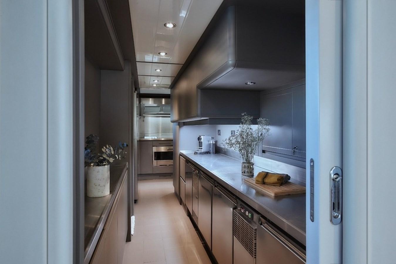 a kitchen with a large island aboard CAMARIK Yacht for Sale