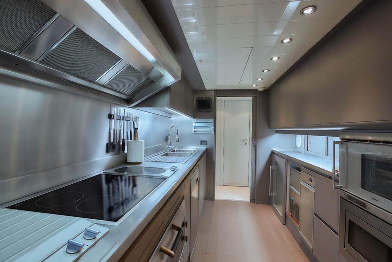 a kitchen with a large island aboard CAMARIK Yacht for Sale