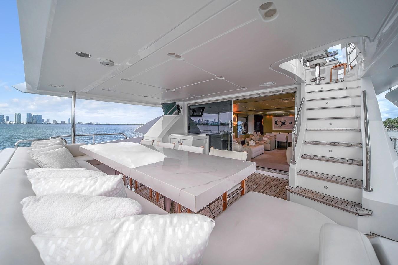 a boat with a bed and a table in the middle aboard 95 RAISED PILOTHOUSE Yacht for Sale