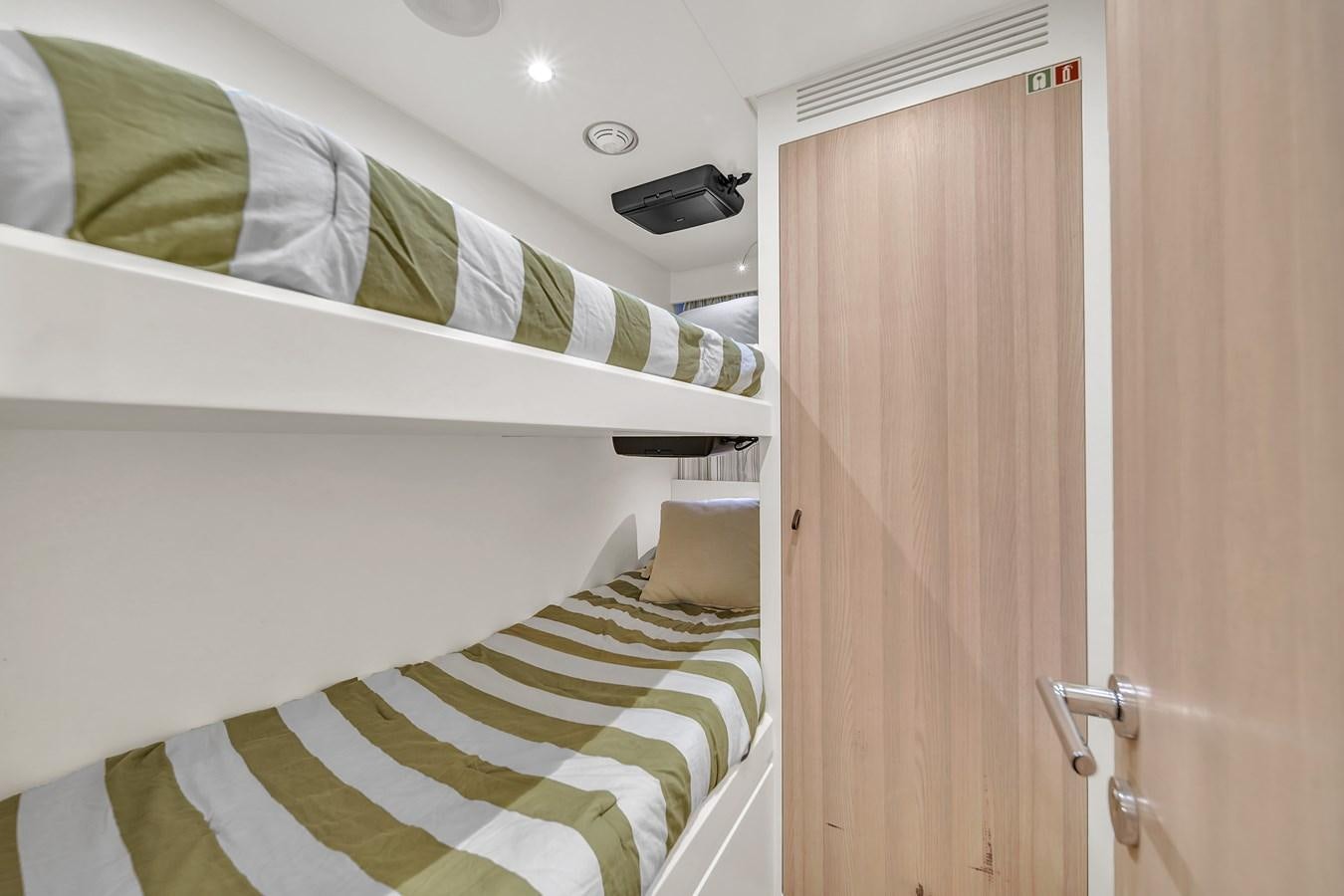 a room with a bed and a closet aboard 95 RAISED PILOTHOUSE Yacht for Sale