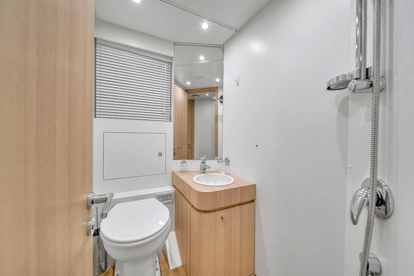 a bathroom with a toilet and sink aboard 95 RAISED PILOTHOUSE Yacht for Sale