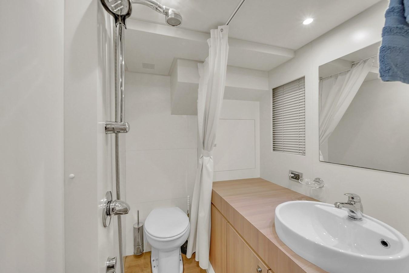 a bathroom with a toilet and sink aboard 95 RAISED PILOTHOUSE Yacht for Sale
