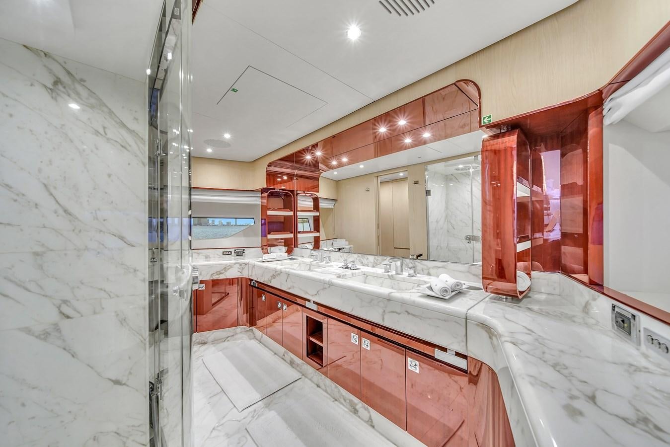 a bathroom with red cabinets aboard 95 RAISED PILOTHOUSE Yacht for Sale