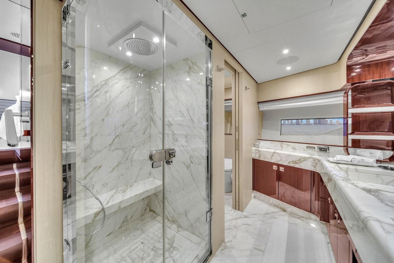 a bathroom with a glass shower aboard 95 RAISED PILOTHOUSE Yacht for Sale