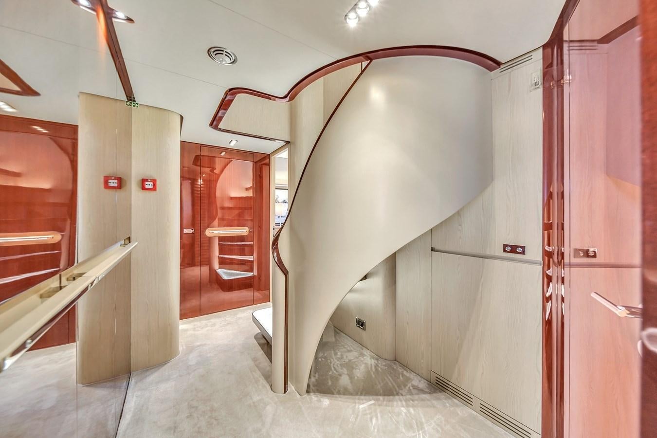 a hallway with a staircase and red doors aboard 95 RAISED PILOTHOUSE Yacht for Sale