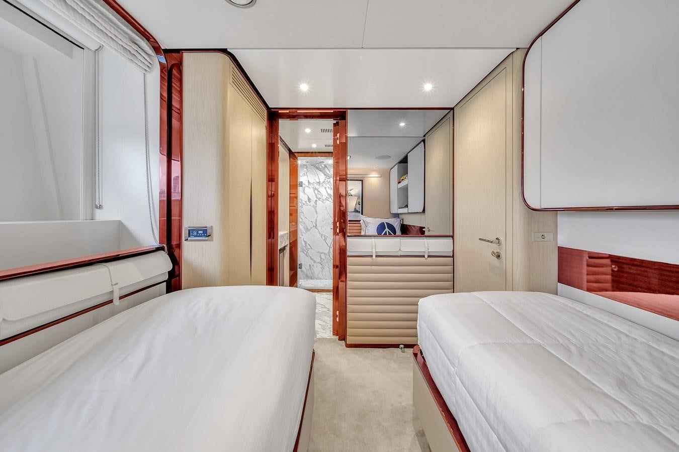 a room with beds and a door aboard 95 RAISED PILOTHOUSE Yacht for Sale