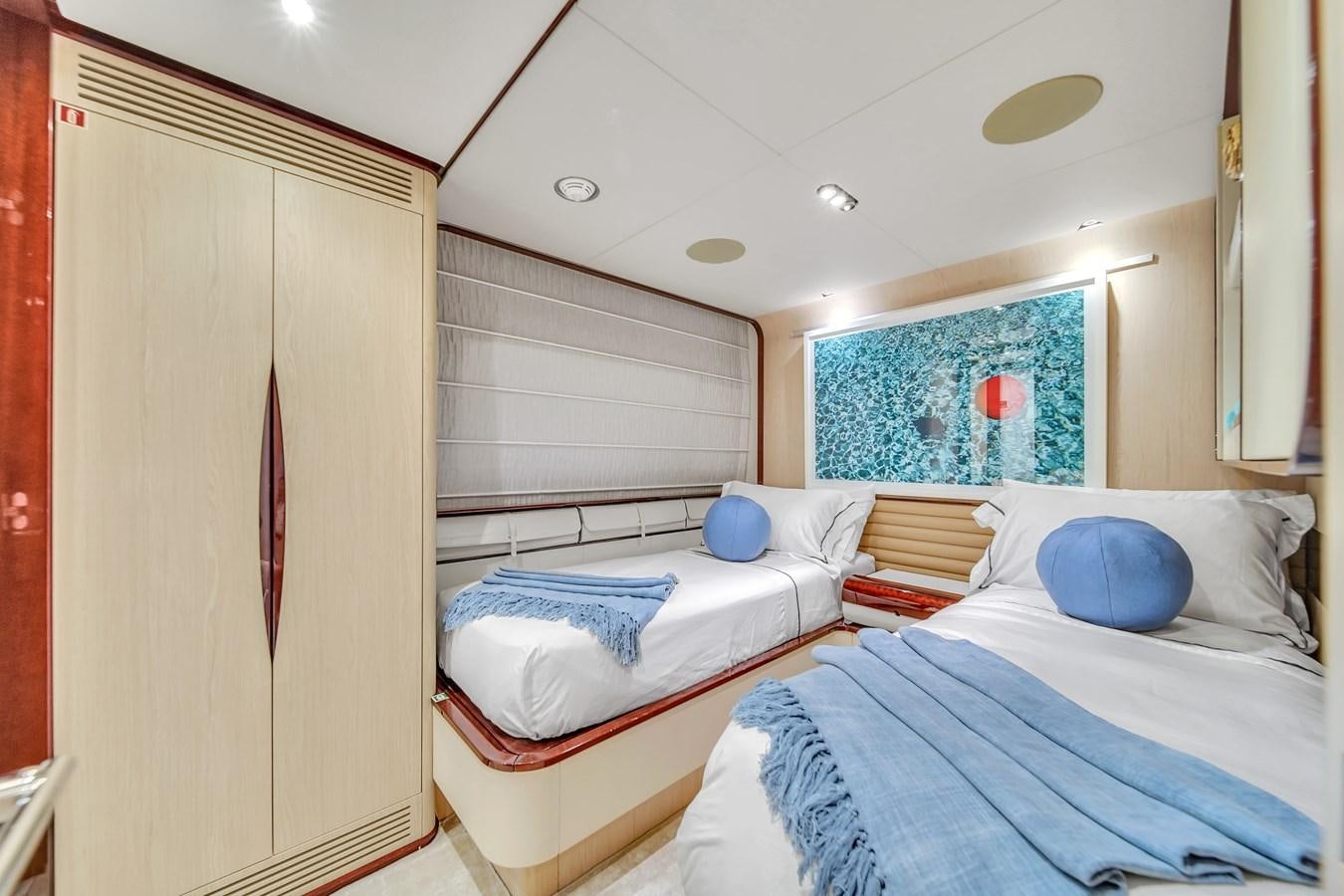 a room with beds and a window aboard 95 RAISED PILOTHOUSE Yacht for Sale
