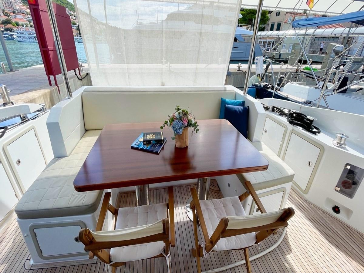 a table with chairs around it aboard TAMARA II Yacht for Sale