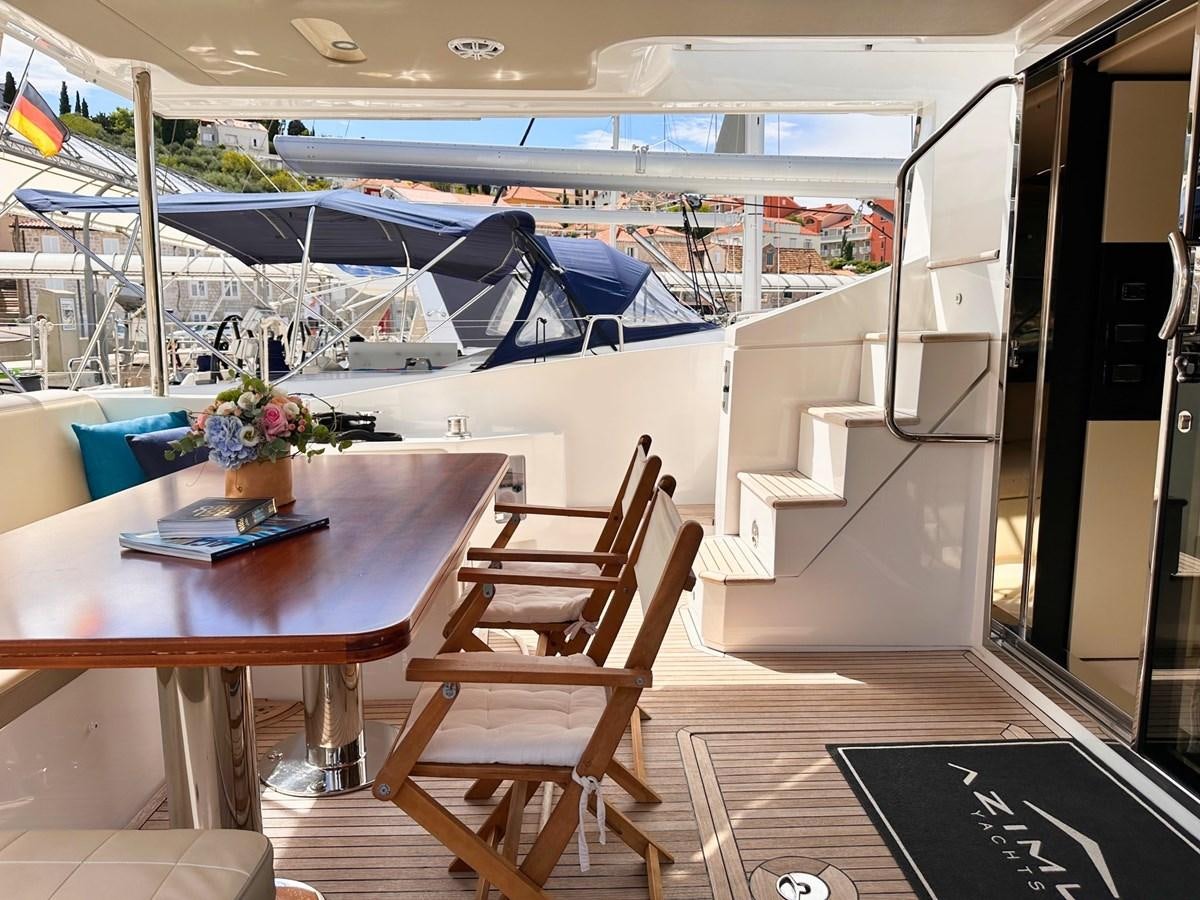 a room with a table and chairs aboard TAMARA II Yacht for Sale