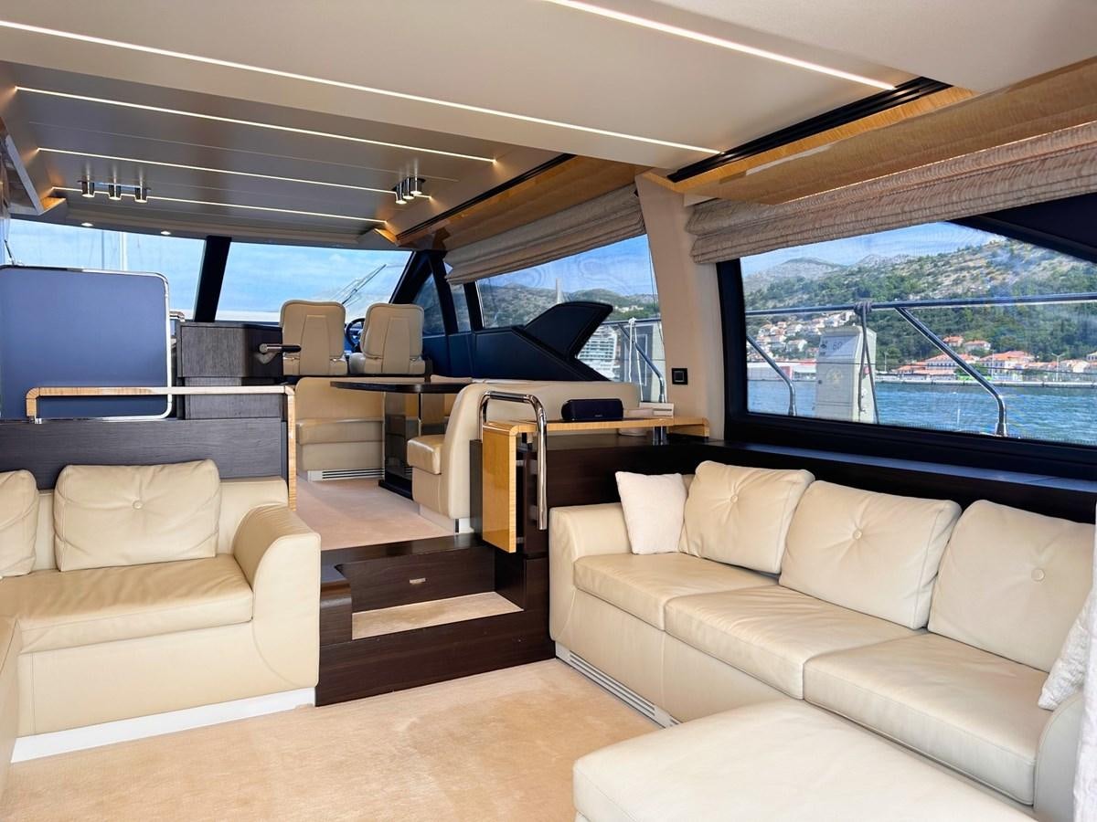 a living room with a view of the water aboard TAMARA II Yacht for Sale