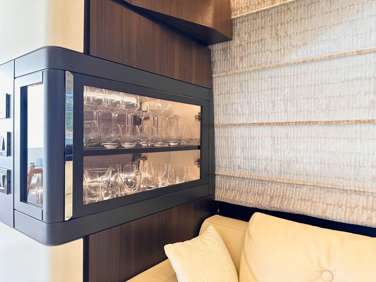 a glass cabinet with wine glasses aboard TAMARA II Yacht for Sale