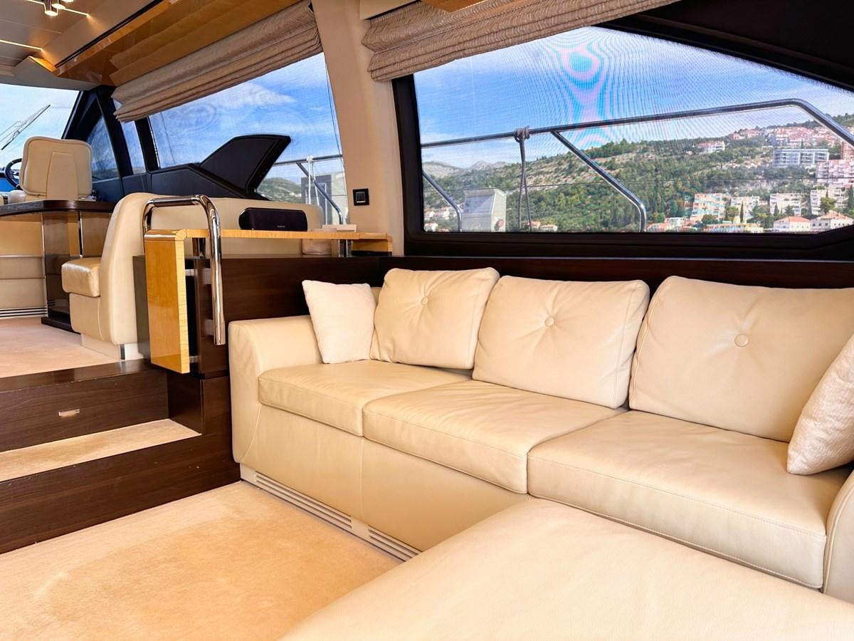 a tan couch in a car aboard TAMARA II Yacht for Sale