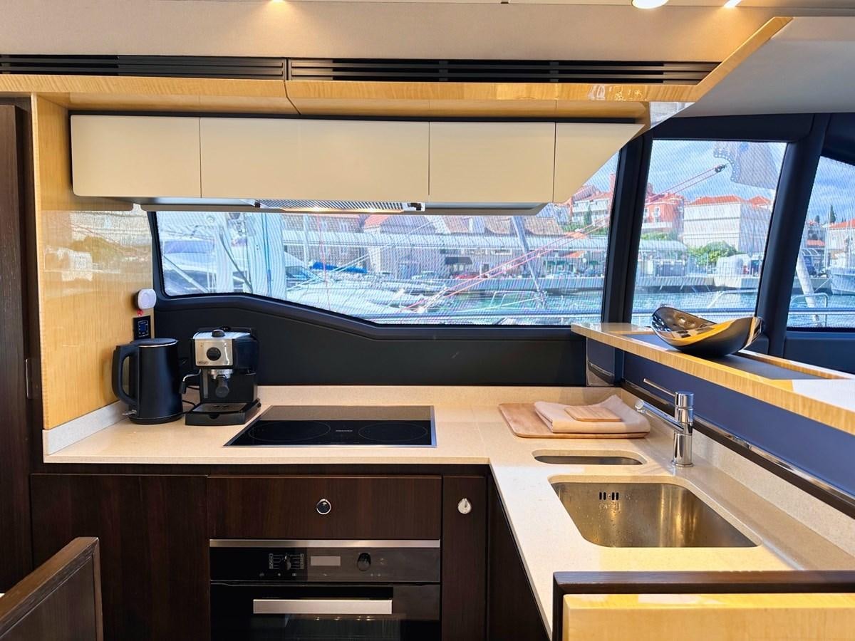 a kitchen with a large window aboard TAMARA II Yacht for Sale