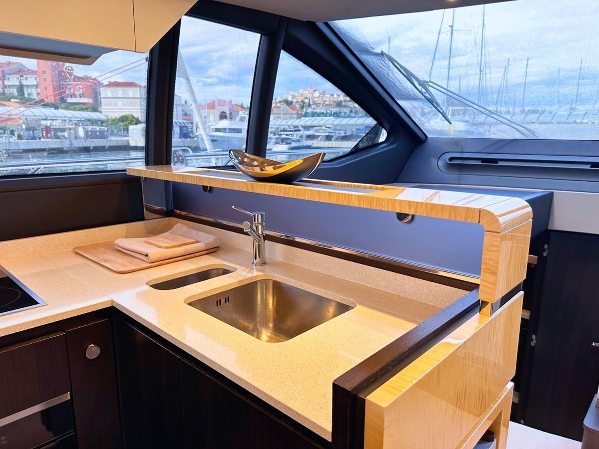 a kitchen with a sink and a window aboard TAMARA II Yacht for Sale