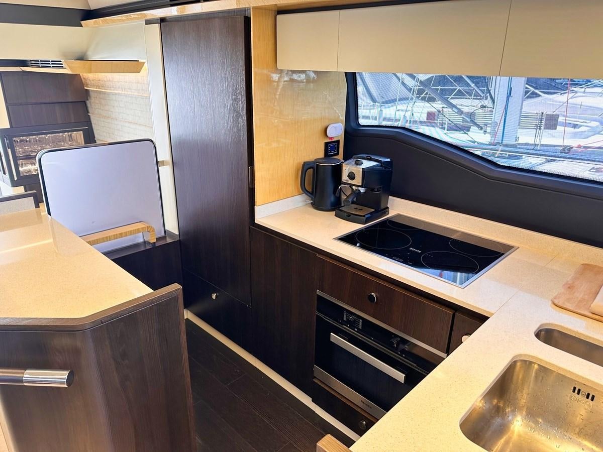 a kitchen with a large window aboard TAMARA II Yacht for Sale