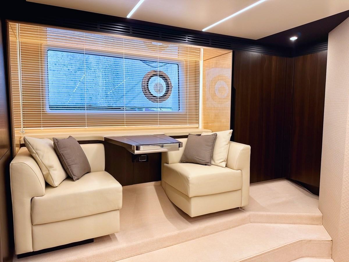 a room with a couch and a window aboard TAMARA II Yacht for Sale