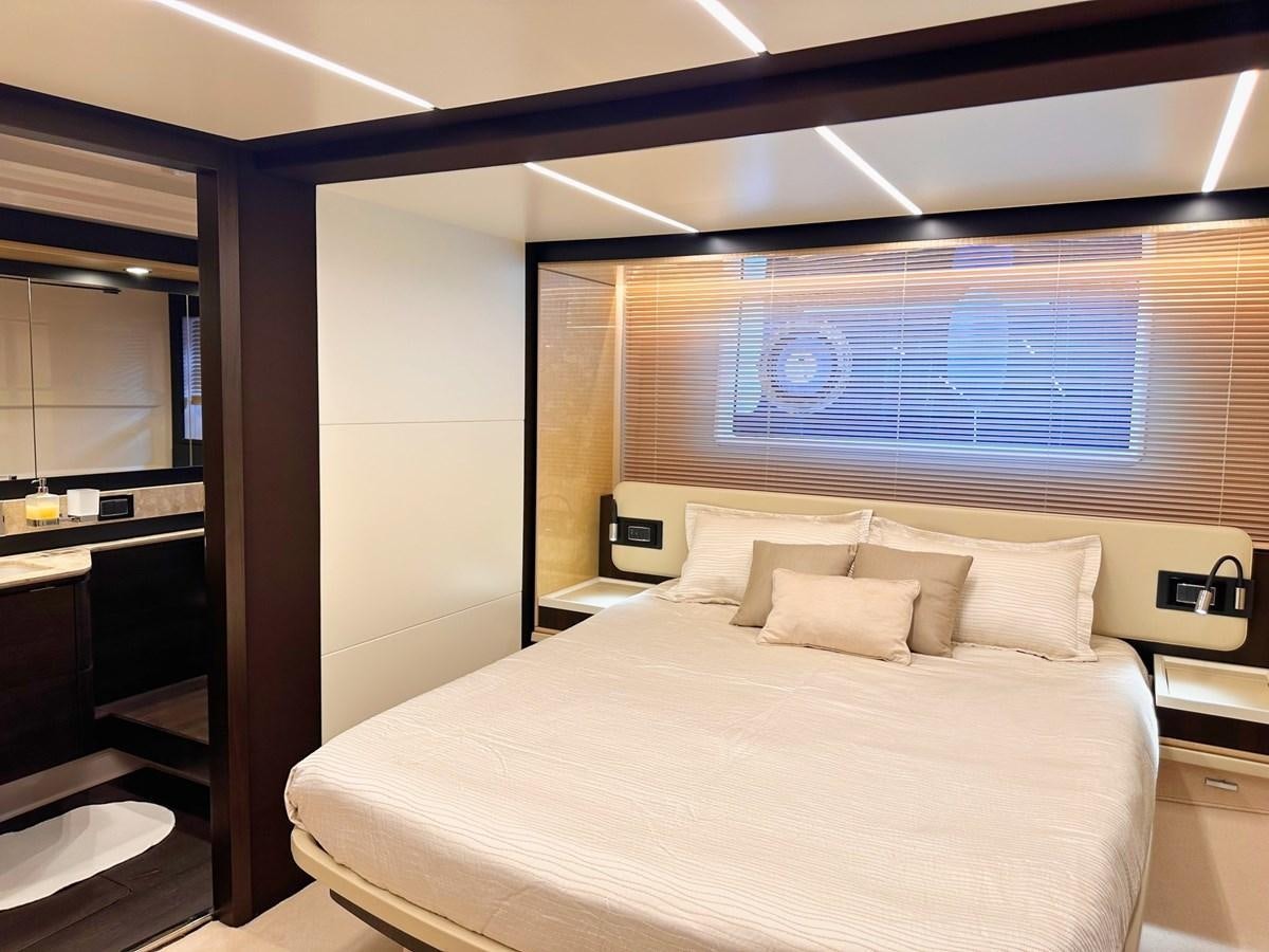 a bed with a white bed spread aboard TAMARA II Yacht for Sale