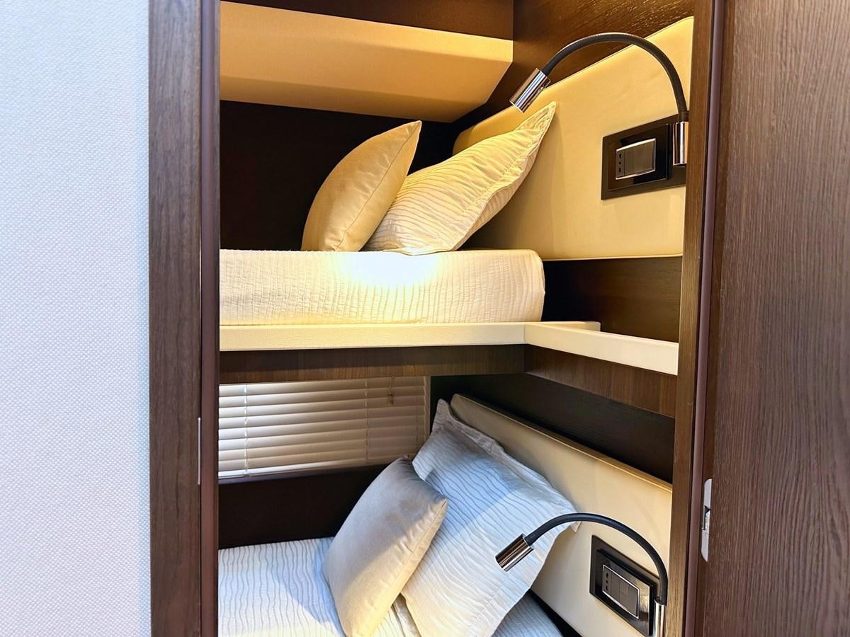 a bed with a lamp on top aboard TAMARA II Yacht for Sale