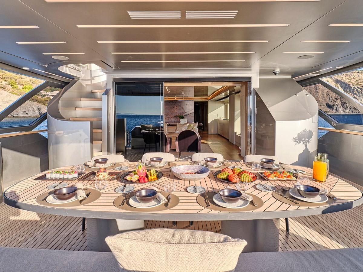 a large kitchen with a table set aboard SEAMMETRY Yacht for Sale