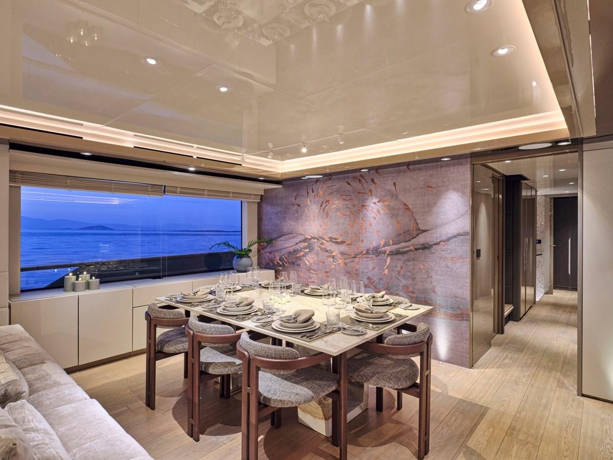 a room with a table and chairs aboard SEAMMETRY Yacht for Sale