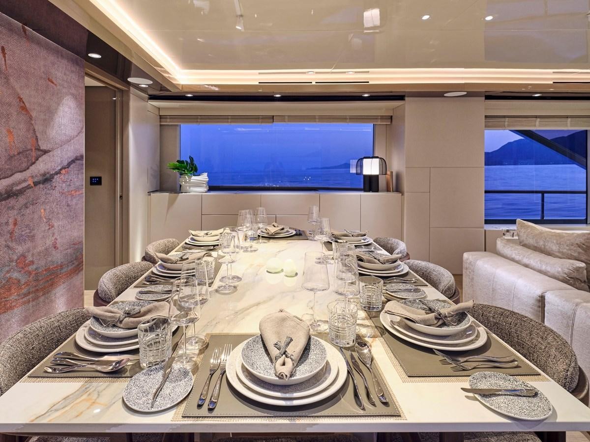 a large white table with plates and silverware on it aboard SEAMMETRY Yacht for Sale