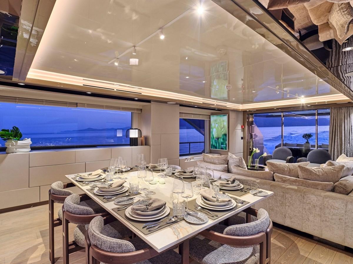 a large dining table in a room aboard SEAMMETRY Yacht for Sale