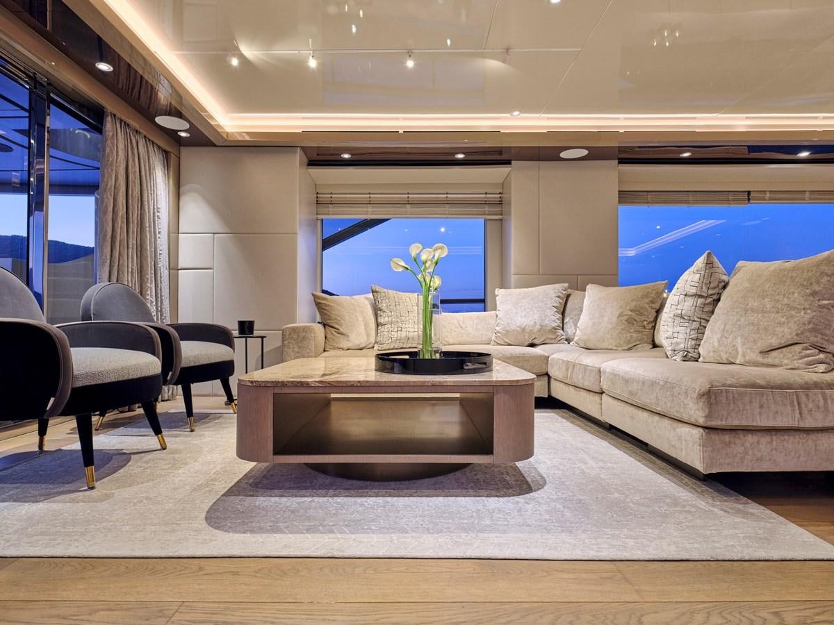 a living room with a couch and a coffee table aboard SEAMMETRY Yacht for Sale