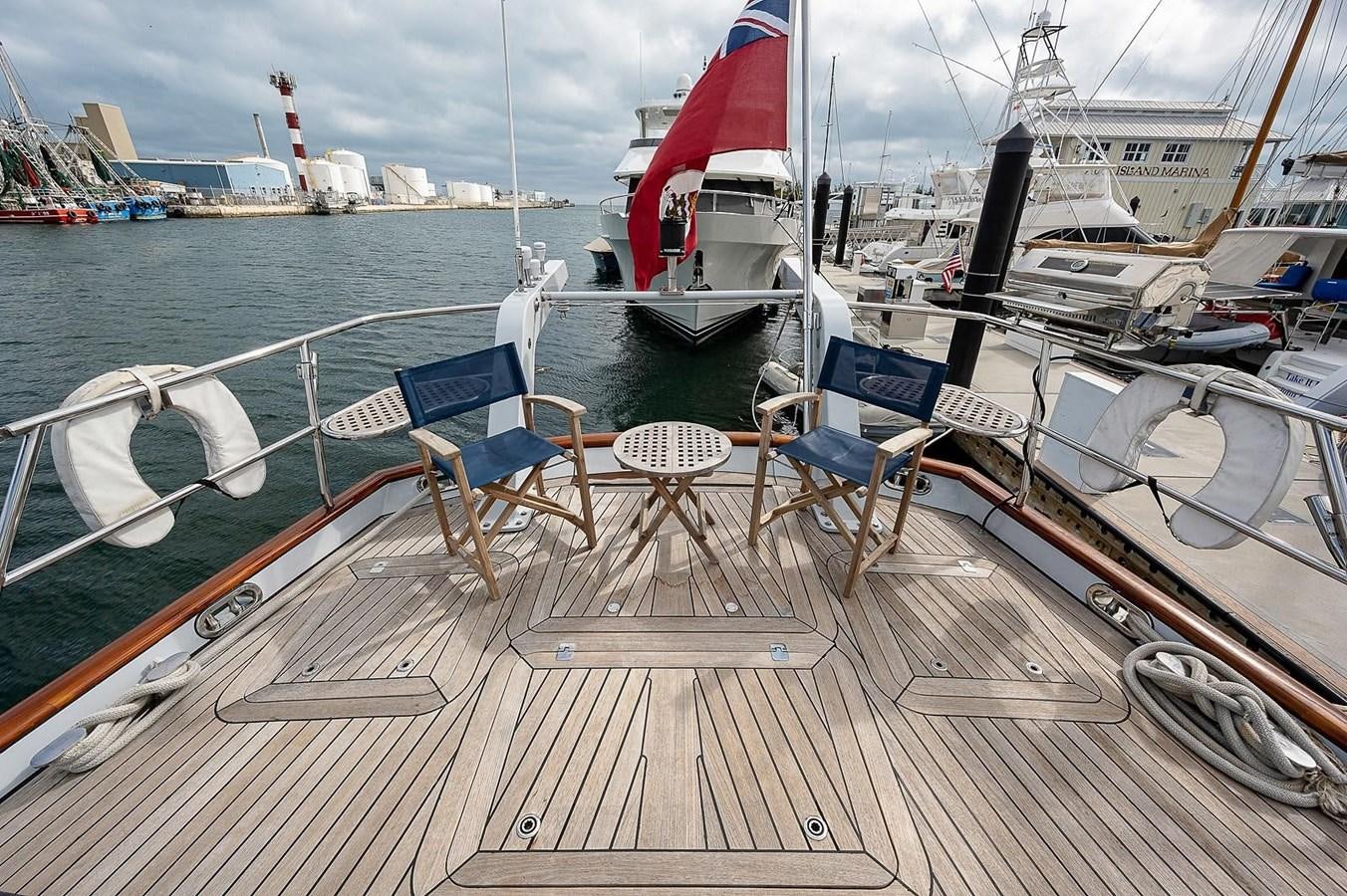 a deck with chairs and tables on it aboard CABOCHON Yacht for Sale