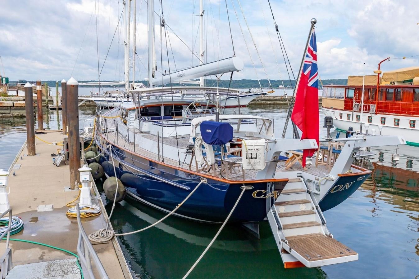 a boat docked at a pier aboard CABOCHON Yacht for Sale