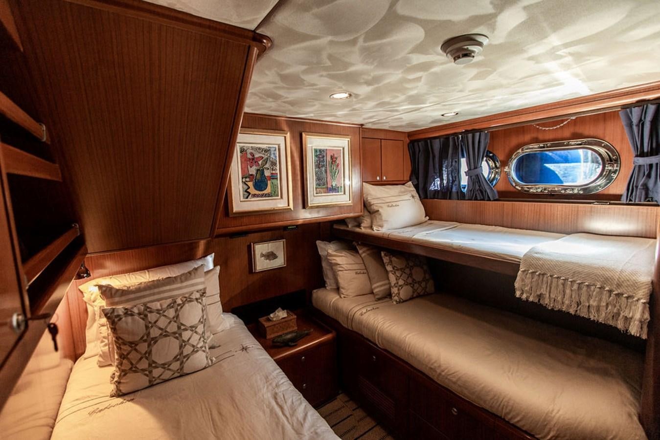 a room with a bed and a mirror aboard CABOCHON Yacht for Sale