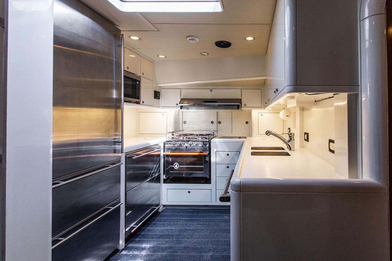 a kitchen with a glass door aboard CABOCHON Yacht for Sale