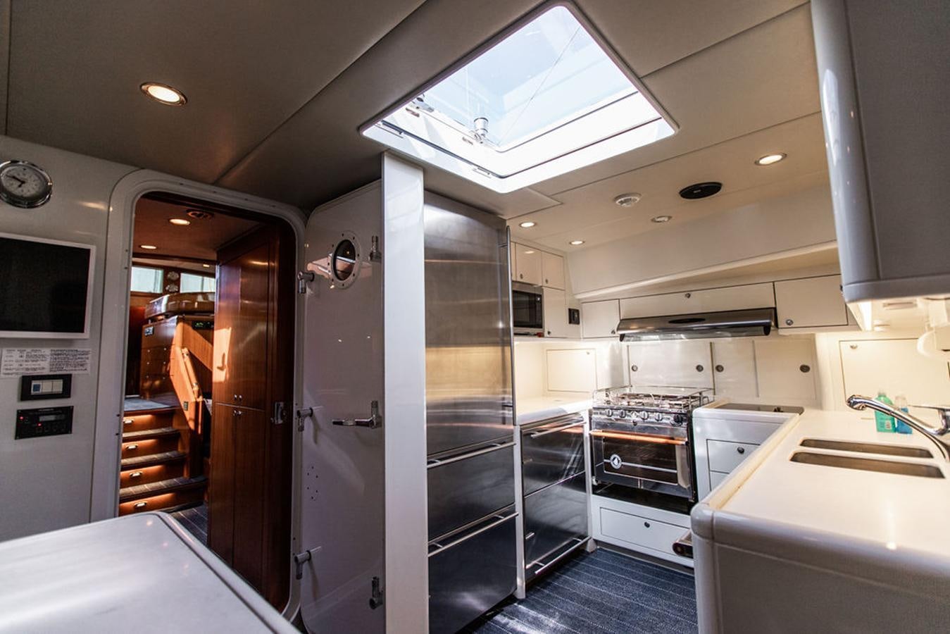 a kitchen with a glass door aboard CABOCHON Yacht for Sale