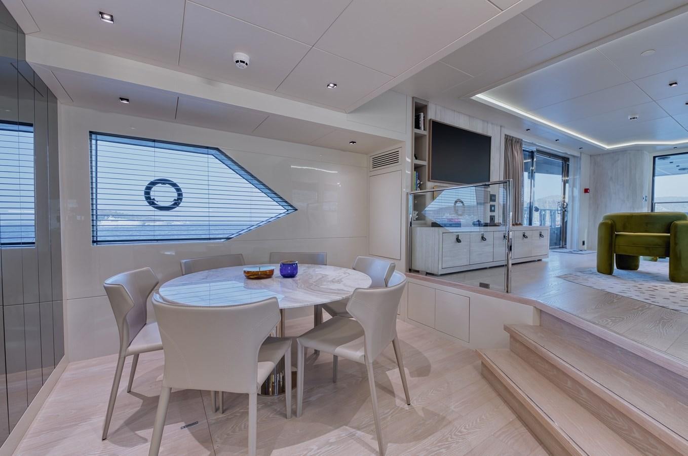 a large kitchen with a table and chairs aboard ROCK X Yacht for Sale